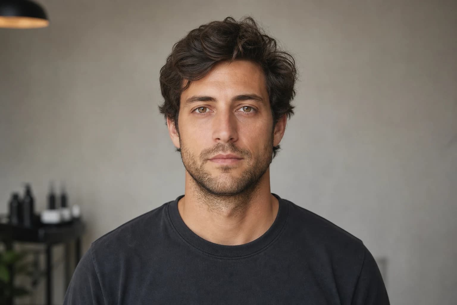 Man with an ordinary overgrown wavy hairstyle before the haircut preview